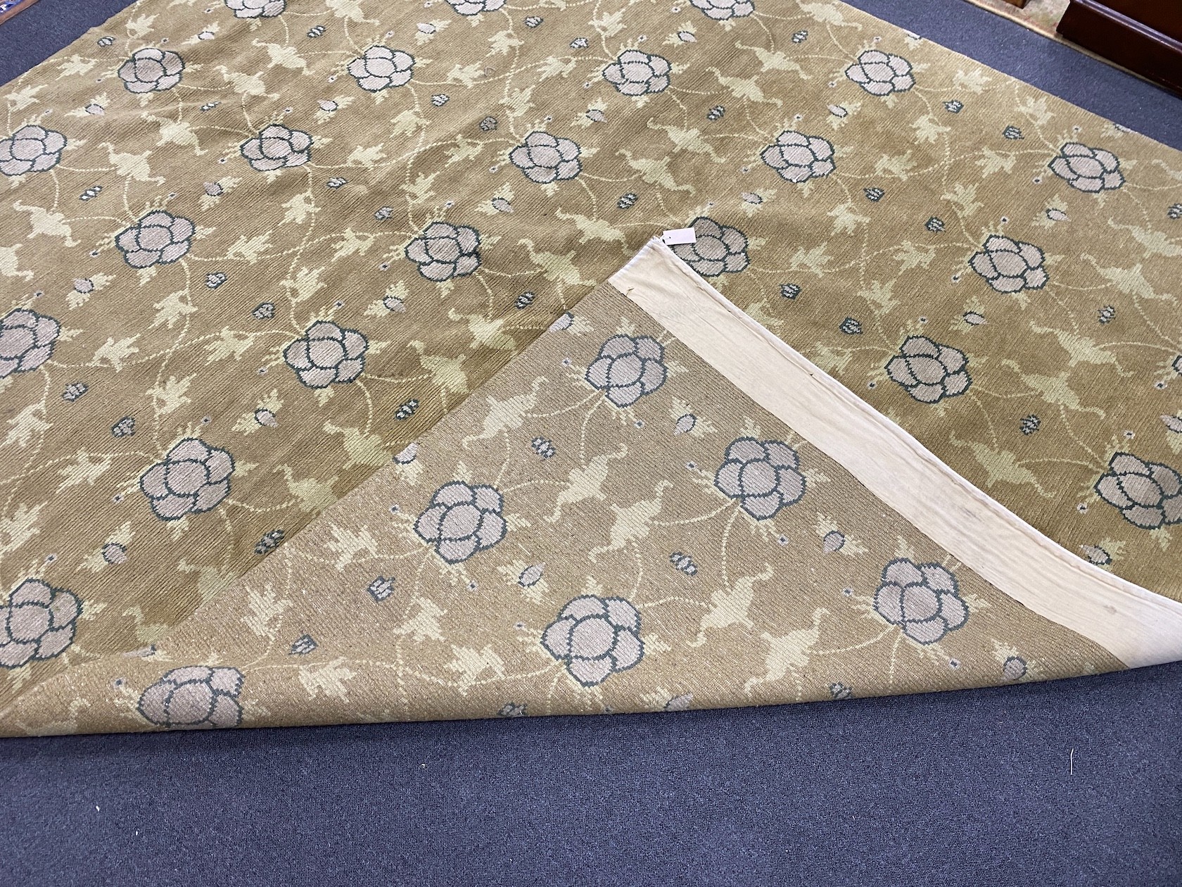 An Arts and Crafts style pale green ground carpet, 300 x 250cm